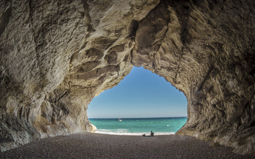 Photo of the Cala Luna Beach Cave and the blue Mediterranean sea in Sardinia, Italy